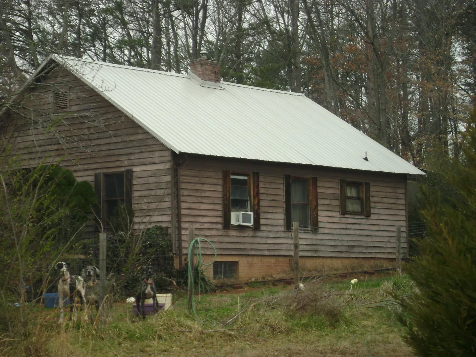White metal roof on an old wood sided farmhouse, from a Metal Roof Installation job in Sun City